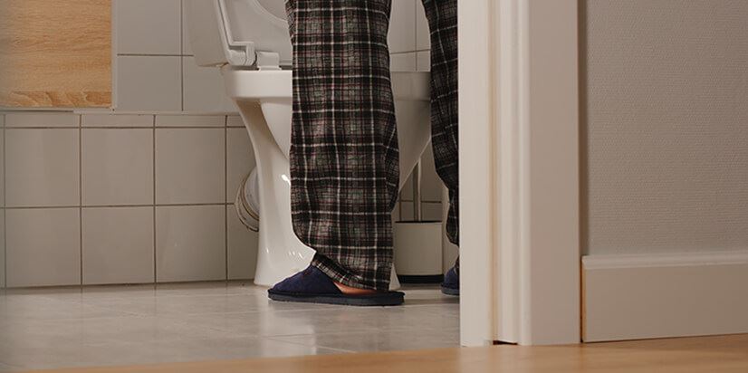 man standing in front of the toilet