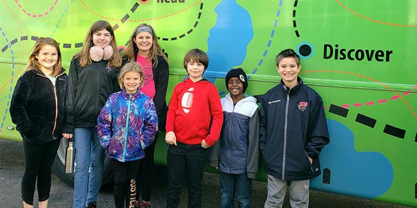 kids and teens in front of a map