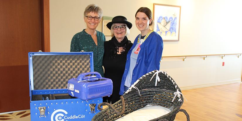 3 women with a toy chest and a bassinet