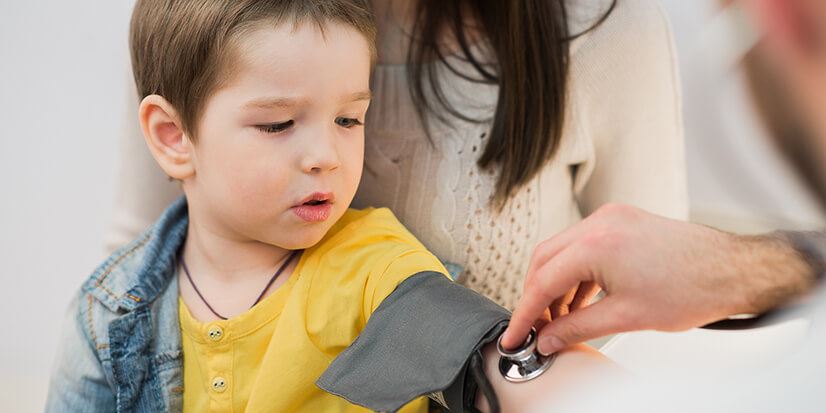 young boy having blood pressure test