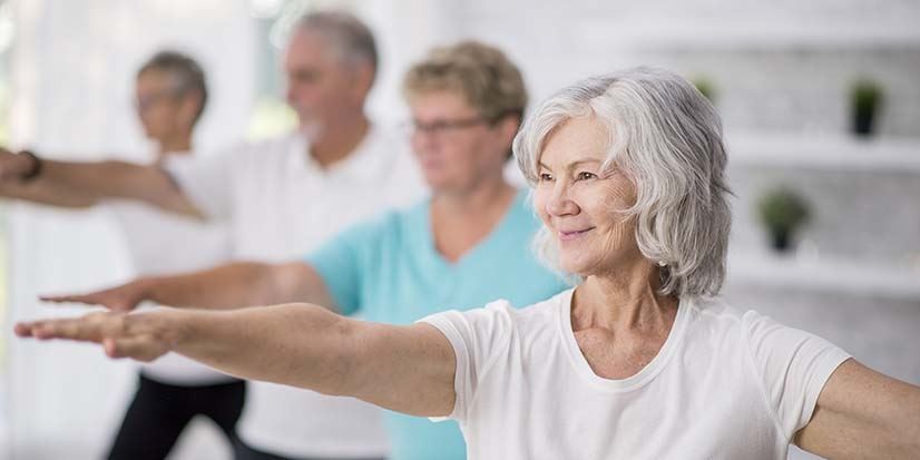 elderly people doing yoga