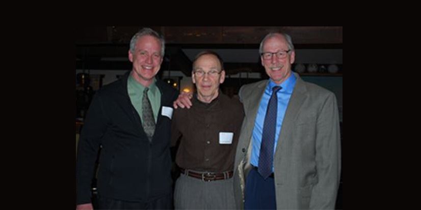 three men posing for a photo