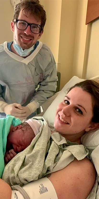 A husband and wife are with their newborn son at a hospital