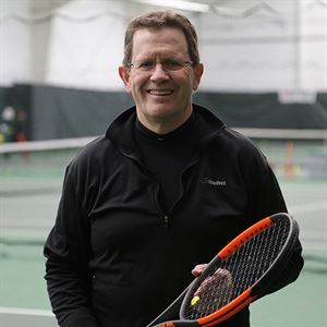 man holding tennis racket 
