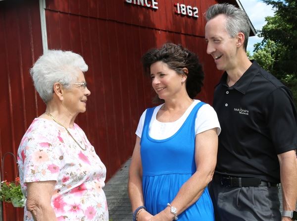 three people smiling at each other