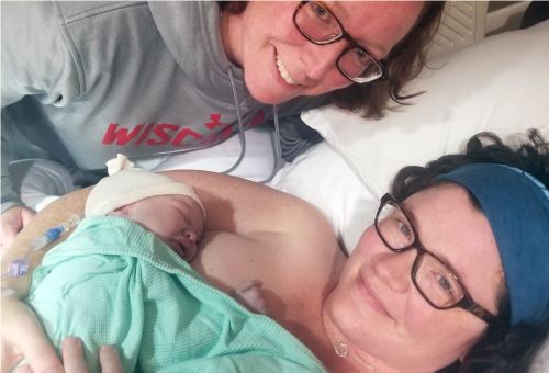 newborn baby on woman's chest
