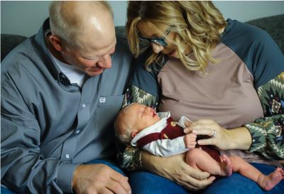 two people holding baby