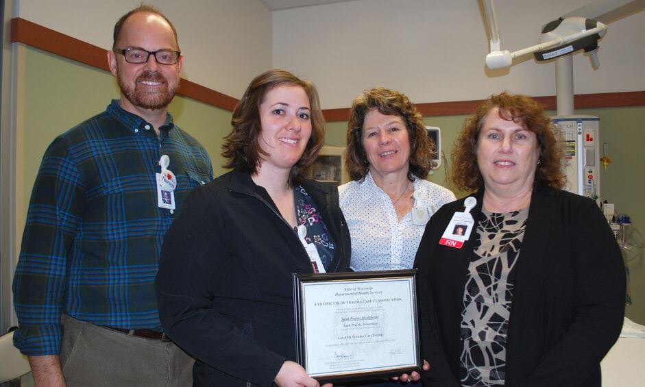 four people holding award