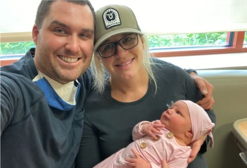 parents holding baby